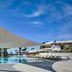 Parklane, a Luxury Collection Resort & Spa, Limassol pool deck with shaded canopy and lounge chairs in Pyrgos