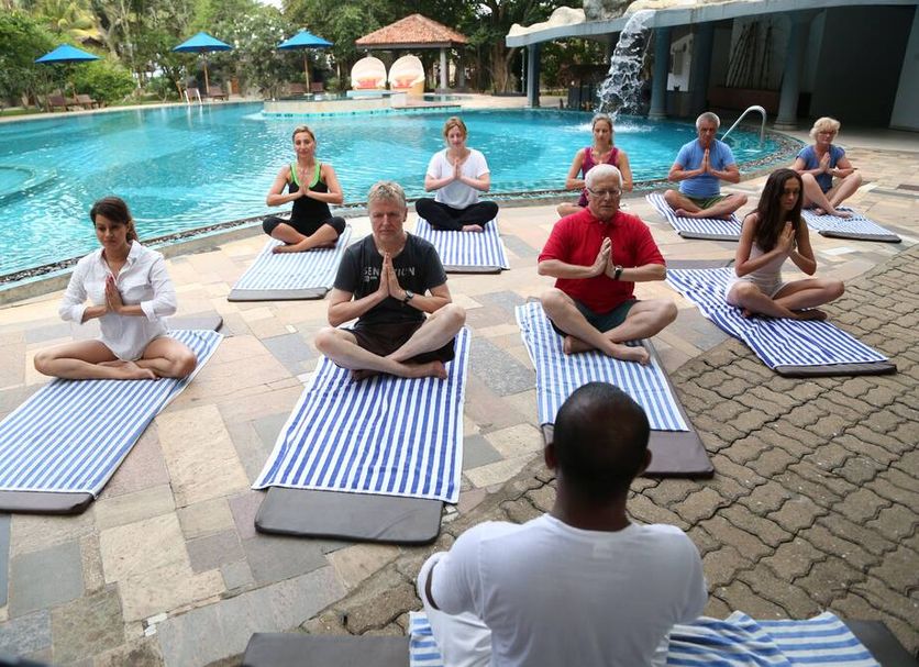 Yoga class by the pool at Siddhalepa Ayurveda Resort in Molligoda