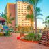 Hot Beach Resort in Olímpia with palm-lined resort grounds and colorful outdoor stage
