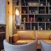 Saint Louis Bastille Paris lounge with tan leather sofa, bookshelves and fireplace