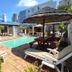 Dolphin Inn Blouberg in Cape Town with a small outdoor pool, sun loungers, and palm trees