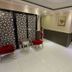 White Fort Hotel Dubai hallway with decorative screen chairs and glossy tile flooring