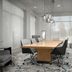 Hilton Garden Inn Tallahassee Central meeting room with conference table, chairs, fireplace and wall-mounted TV