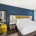 SureStay by Best Western Santa Monica guest room with king bed and blue accent wall