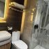 EGI Resort and Hotel in Lapu-Lapu City bathroom with sink, toilet and glass shower enclosure