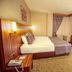 Adana Garden Business Hotel in Adana guest room with double bed, desk, wall TV and curtained window