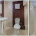 OYO 1805 Blue Orchid Corporate Inn Kolkata bathroom with toilet, sink, mirror, and shower area