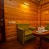 Hotel Jagjeet, Darjeeling: cozy wood-paneled seating nook with two green armchairs and a small table