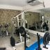 Elite Hotel, Port Au Prince fitness room with exercise bikes, weight machine and mirrored wall