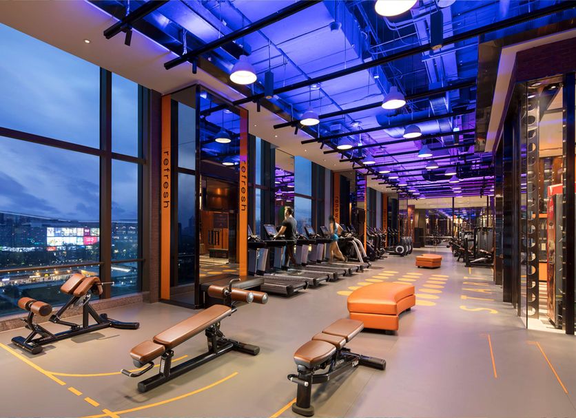 Shangri-La Jinan fitness center with treadmills, benches, and city views in Jinan