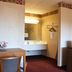 Regency Inn Richmond room with vanity, desk, chair, and microwave in Richmond