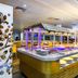 Atrium Hotel Heathrow in Hounslow features a buffet station with colorful lighting and food counters