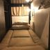 Hotel Owl Tokyo Nippori in Tokyo, compact single bed cabin with built-in shelving and curtain divider