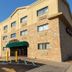 Floral Park Motor Lodge in Queens, exterior entrance with stone facade and parking lot