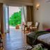 Hondaafushi Island Resort in Hanimaadhoo guest room with open terrace doors and ocean-view greenery