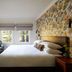 The Stavrand Russian River Valley guest room with king bed, floral accent wall, and windows in Guerneville