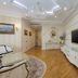 Boutique Hotel Buta, Minsk: elegant suite with chandelier, TV, ornate mirror, and parquet flooring