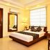 Hotel Shipra International in New Delhi bedroom with double bed, floor lamp, wall mirror and window blinds