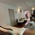 Casa Hotel Boyaca Real Bogotá guest lounge with sofa, coffee table, and sliding glass doors