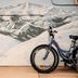 Rad Hostel in Colorado Springs mural with mountain landscape and a bicycle in front