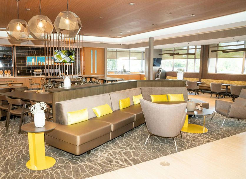 SpringHill Suites by Marriott Woodbridge lobby lounge with bar, sofa seating and pendant lights