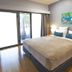 Kununurra Country Club Resort room with king bed, bedside lamps and sliding doors to a balcony in Kununurra