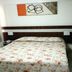 Resort L'acqua Diroma V room in Caldas Novas with double bed, bedside lamps, window curtains and wall art