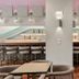 Calamos Beach Family Club in Agii Apostoli bar area with stools, mirrored shelves and pink accent lighting