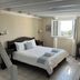 Maria's Place - Adults Only in Oia room with bed, desk, and window view