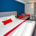 Holiday Inn Express Burton Upon Trent guest room with king bed, sofa and wall-mounted TV