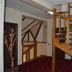 Magic Club in Bușteni interior with wooden staircase and red carpeted hallway
