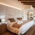 Hotel Plaza Obradoiro by Bossh! Hotels room in Santiago de Compostela with a bed, wooden beams and a bathtub