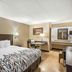 Red Roof Inn Danville PA guest room with king bed, desk, lamp, and vanity