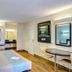 Motel 6 Dickson, TN guest room with bed, desk, chairs, wall TV and wood floors