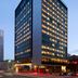 citizenM Austin Downtown tower in Austin at dusk with illuminated windows and street-level entrance