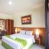 Mirah Hotel & Resort Banyuwangi guest room with king bed, desk, vanity, and wall art in Banyuwangi