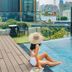 Tastoria Collection Sukhumvit rooftop pool in Bangkok with city skyline view and seated guest