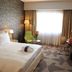 Radisson Blu Hotel, Abidjan Airport guest room with king bed, desk, seating area and large window