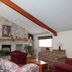 Americas Best Value Inn Annandale lounge with stone fireplace, plaid sofa and vaulted ceiling
