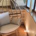 Landhaus Lauble in Hornberg: hanging egg chair with cushion in a cozy indoor lounge corner