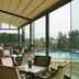 Kaya Izmir Thermal & Convention in Izmir with glass-walled lounge seating beside an outdoor pool