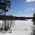 Lakeside Bed & Breakfast in Florence overlooking a frozen lake with snowy shoreline and pine trees