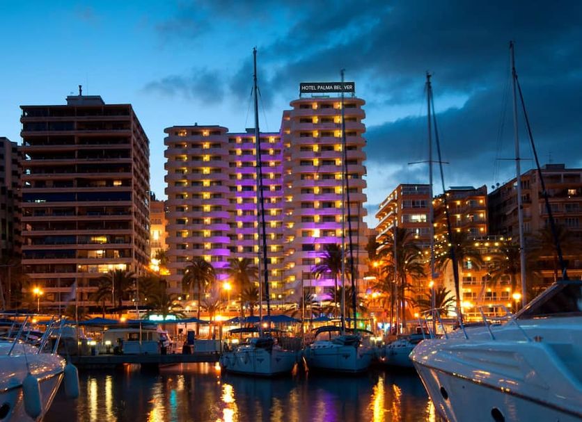 Hotel Palma Bellver, Affiliated by Meliá in Palma de Mallorca with illuminated waterfront and marina at dusk