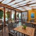 Unahotels Eco Hotel Villa Costanza Venezia in Venice, covered outdoor terrace with wooden tables and chairs
