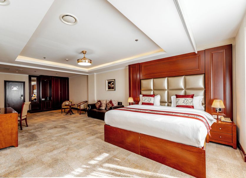Premium Hotel Ulaanbaatar guest room with king bed, seating area, and bright modern interior