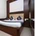 Vishal Hotel Near New Delhi Railway Station room with wooden bed, mirrored wardrobe, and padded headboard in New Delhi