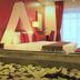 Mekong Angkor Palace Hotel in Siem Reap room with canopy bed, red accents, and lotus-petal bath