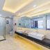 Marriott Hotel Yunfu bathroom with glass shower, double vanity, and large mirror