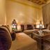 Kasbah Tizzarouine in Boumalne Dadès, cozy lounge with low seating, lanterns and patterned coffee table