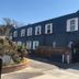 Americas Best Value Inn & Suites Royal Carriage in Jamestown, dark blue hotel exterior with porch and balcony